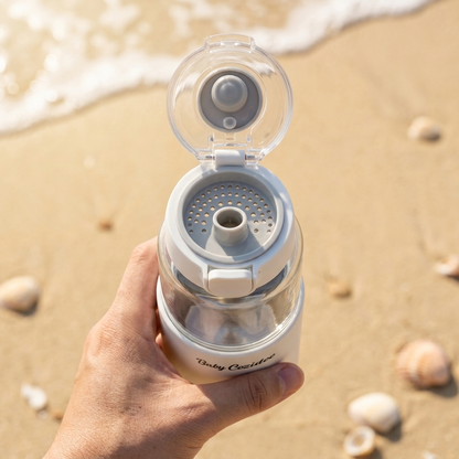 Top-down view of the Babycozidoo bottle warmer with the flip-top fully open, showing the inner spout vent — easy fill, easy pour
