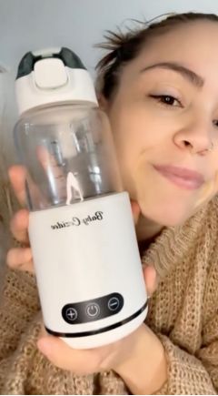Aussie mum selfie holding the Babycozidoo bottle warmer at home