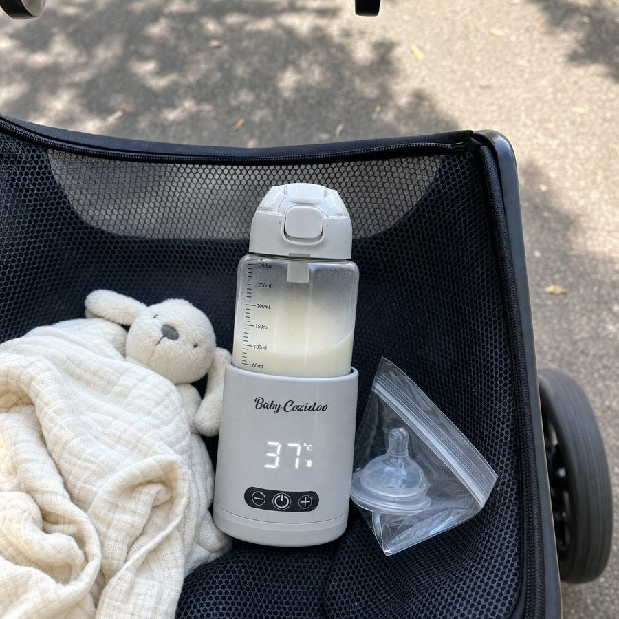 Babycozidoo in a pram basket during a morning walk holding milk at 37 degrees