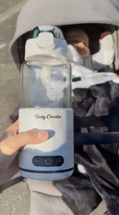 Babycozidoo clipped to a pram handle for hands-free walking
