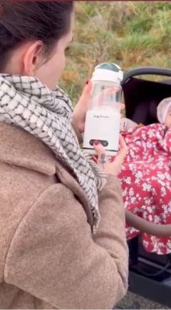 Aussie mum on a pram walk with the Babycozidoo bottle warmer and her baby
